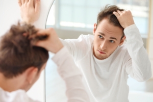 Patient inspecting his hairline