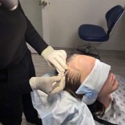 Dr Kelemen during FUE procedure: site making.